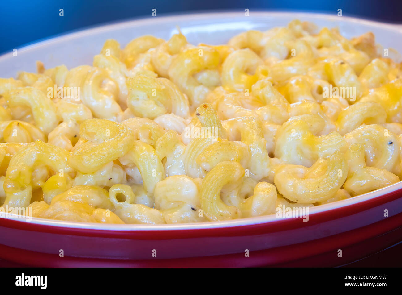 Macaroni and Cheese in Red Ceramic Baking Dish Closeup Stock Photo