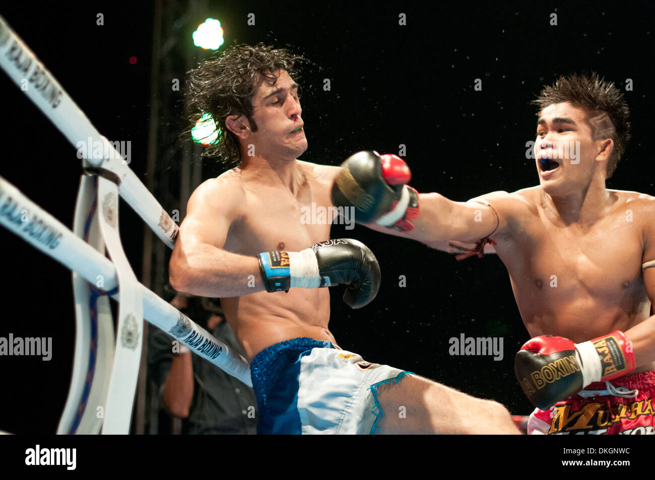 Thai Boxer punches his opponent in the King's Birthday Max Muay Thai Warrior Fight 2013 Stock Photo