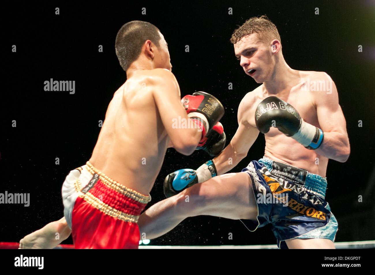 English Thai boxer kicks his opponent in a Thai Boxing Fight Stock Photo