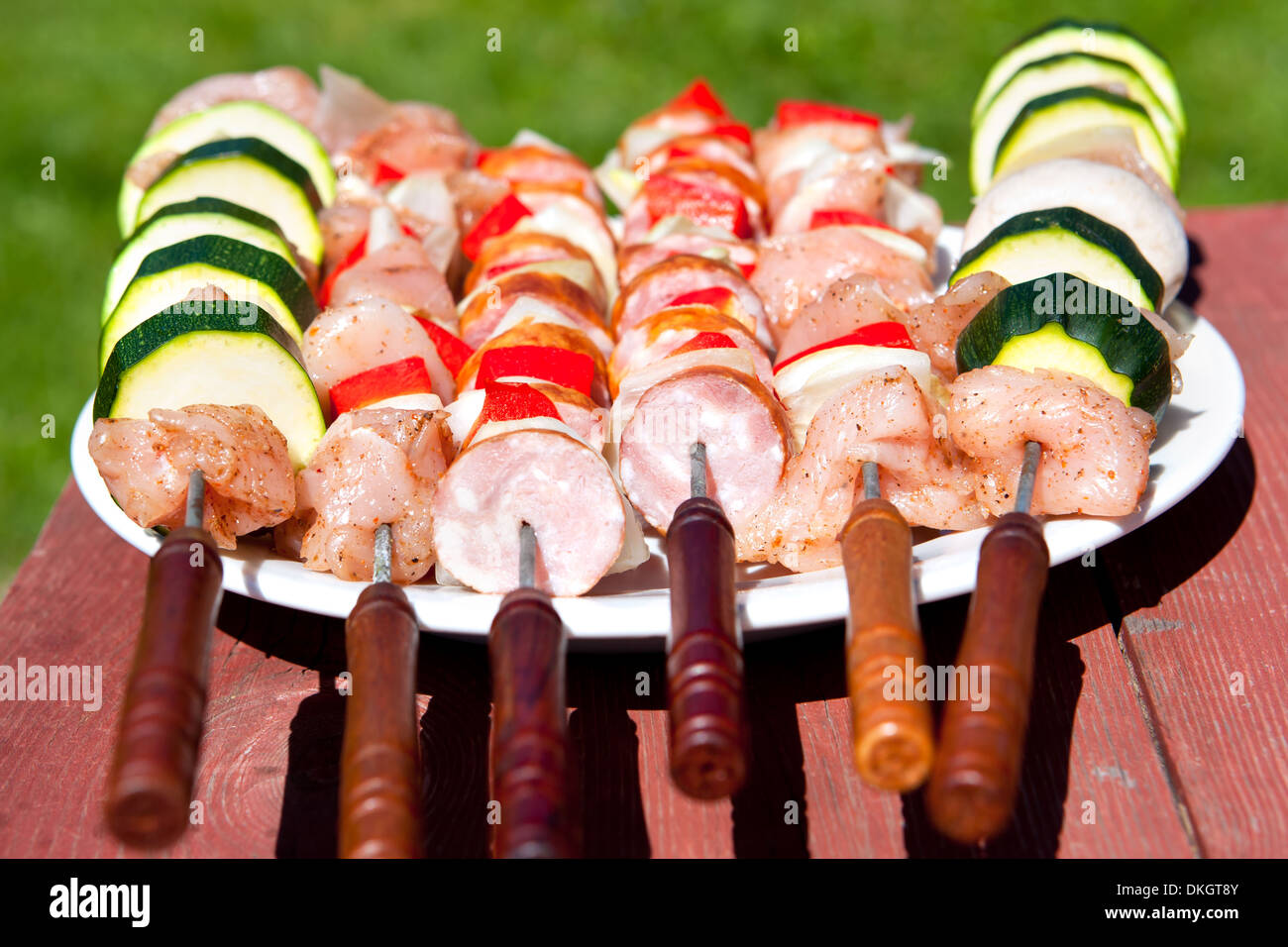 few raw shashliks on a plate, ready t be grilled Stock Photo