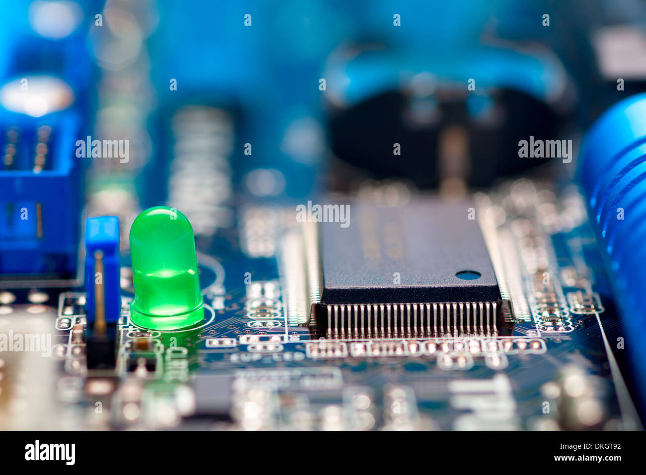 blue electronic circuit (motherboard) with green diode Stock Photo