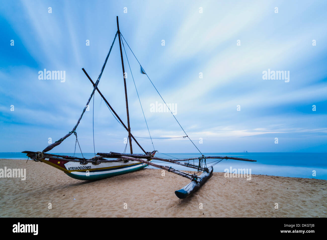Outrigger fishing boat on Negombo Beach at sunrise, Sri Lanka, Asia Stock Photo