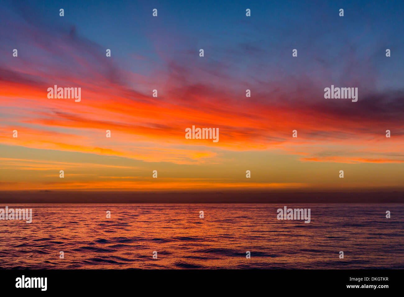 Sunrise off the coast of Akaroa, South Island, New Zealand, Pacific Stock Photo