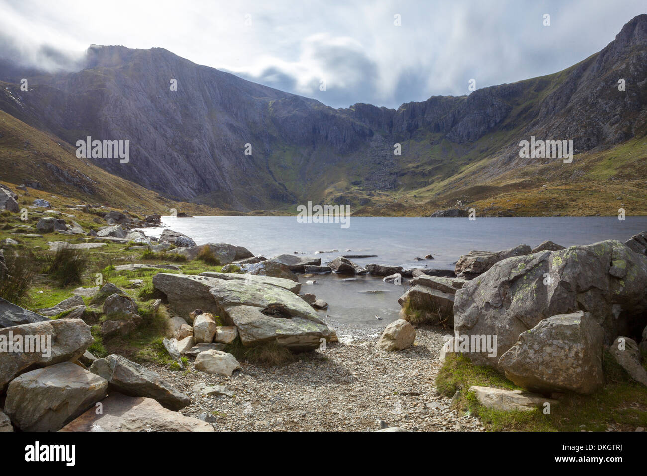 An unnamed source in the Ogwen Valley with the Glyderau mountain range behind, Gwynedd, Snowdonia National Park, Wales, UK Stock Photo