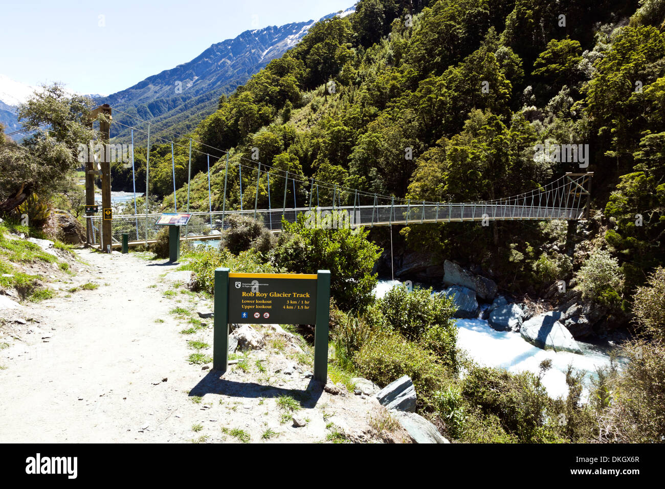 A hiking trail crosses a river by suspension bridge on the South Island