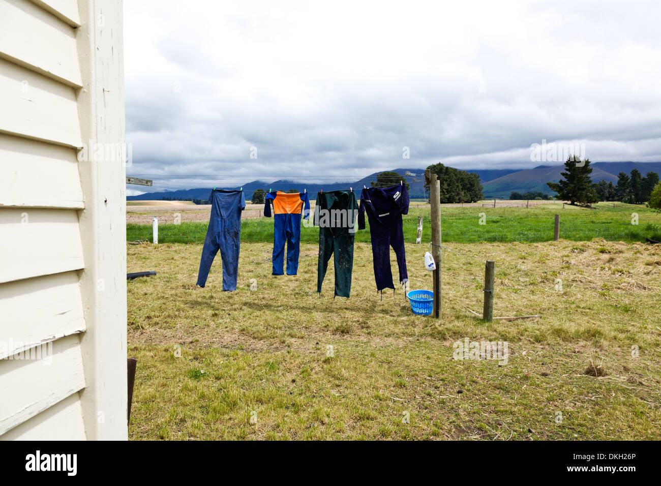 Overalls hang out to dry on a New Zealand farm washing line Stock Photo