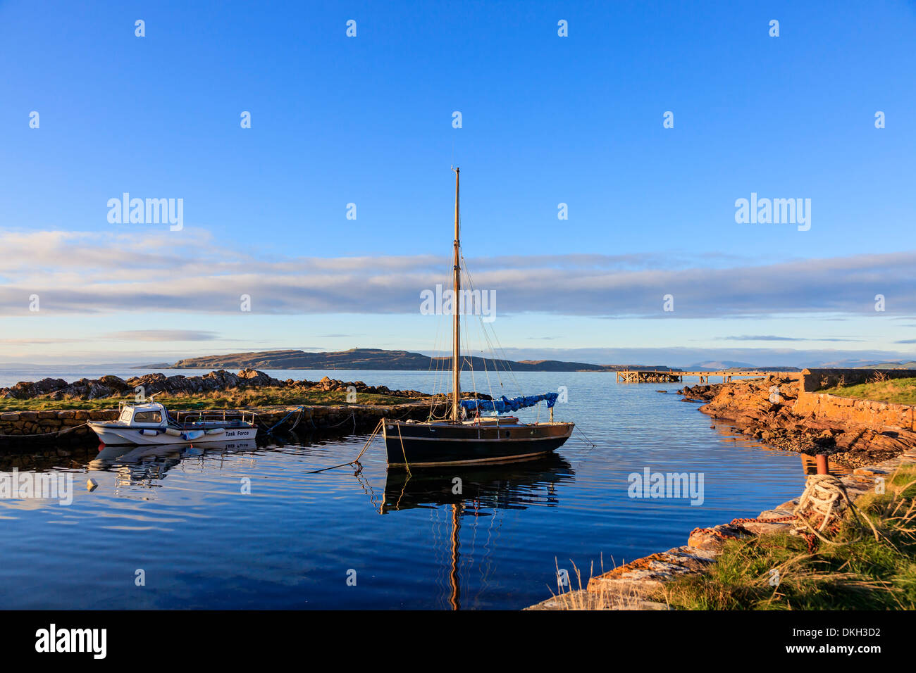 Portencross harbour at sunset, Ayrshire, Scotland, with a view north to the Island of Millport across the Firth of Clyde, UK Stock Photo