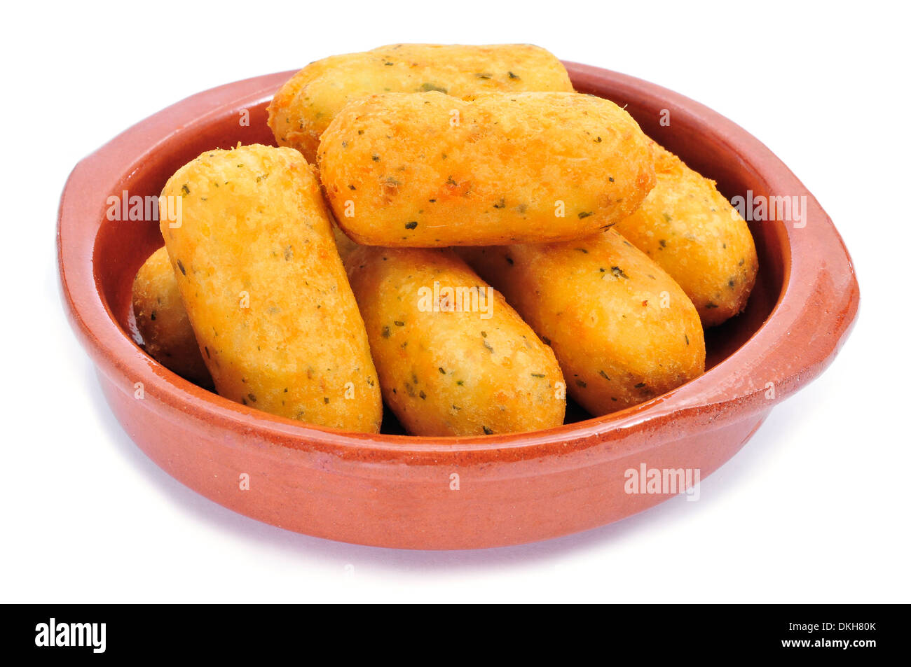 an earthenware bowl with croquetas de bacalao, spanish codfish croquettes, on a white background Stock Photo