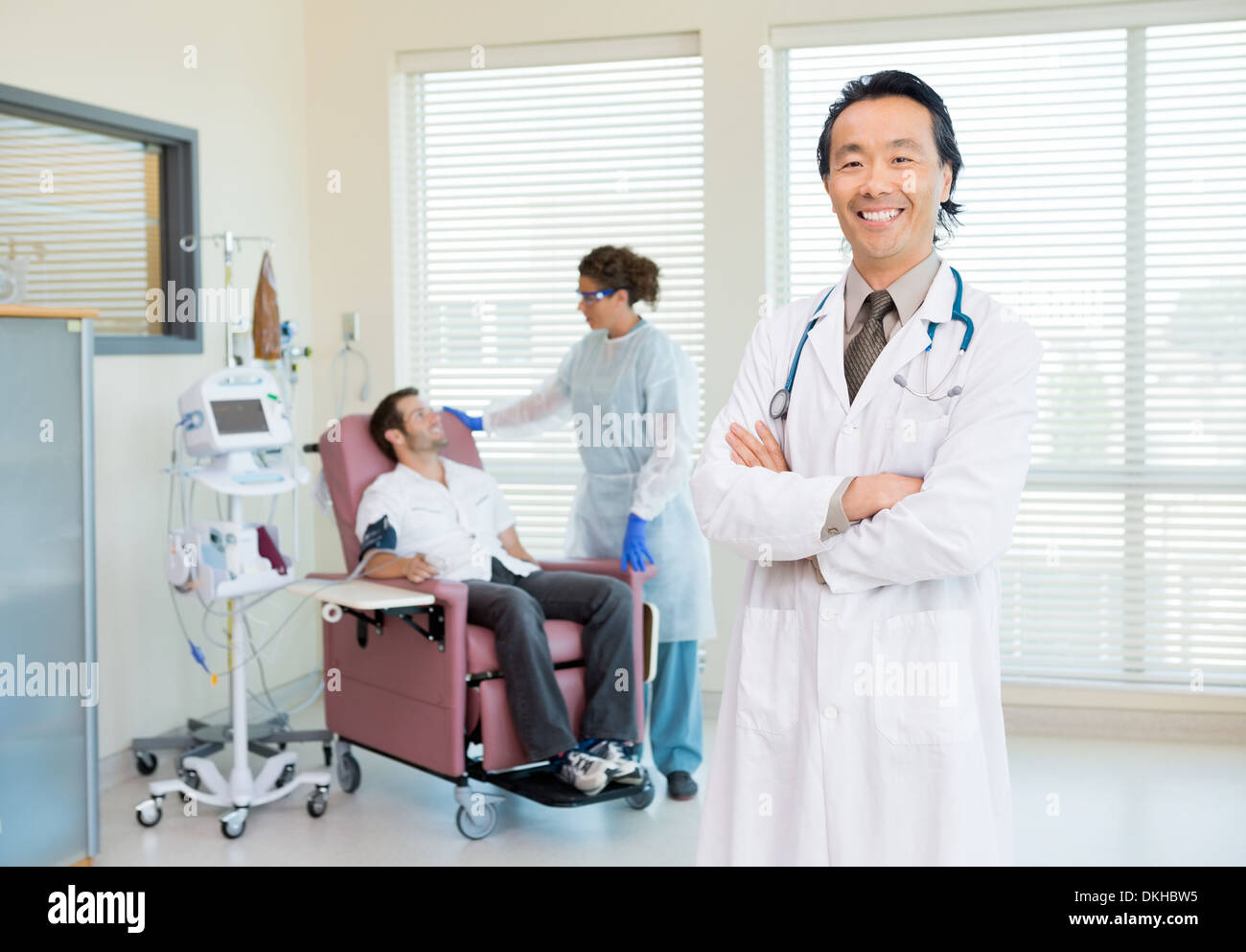 Doctor With Patient Being Examined By Heartbeat Machine Stock Photo