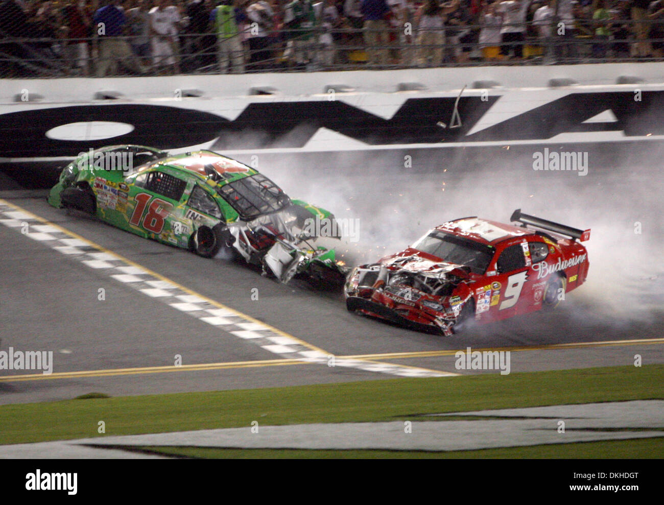 Kyle Busch (18) and Kasey Kahne (9) slid across the finish line after