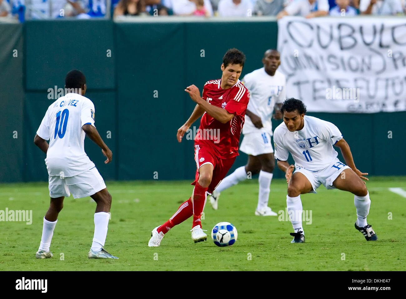 Canada's midfielder Josh Simpson (15) trying to split the Honduras' defense of attacker Marvin Chavez (10) and defender Mariano Acevedo (11) during the CONCACAF Gold Cup quarter finals match between Canada and Honduras at Lincoln Financial Field in Philadelphia, Pennsylvania.  Honduras beat Canada, 1-0. (Credit Image: © Chris Szagola/Southcreek Global/ZUMApress.com) Stock Photo