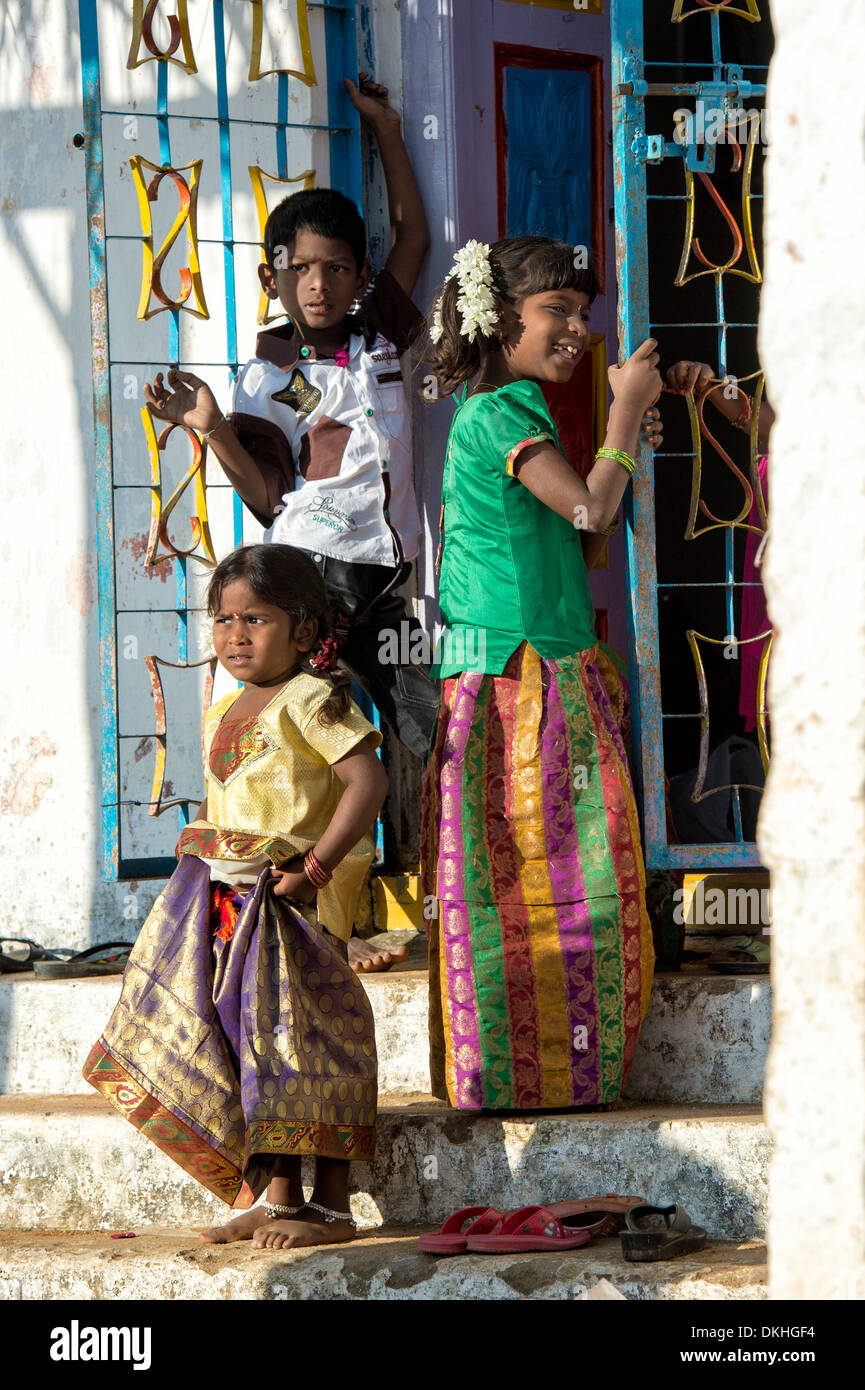 Rural indian children playing on village temple steps in the sunlight. Andhra Pradesh, India Stock Photo