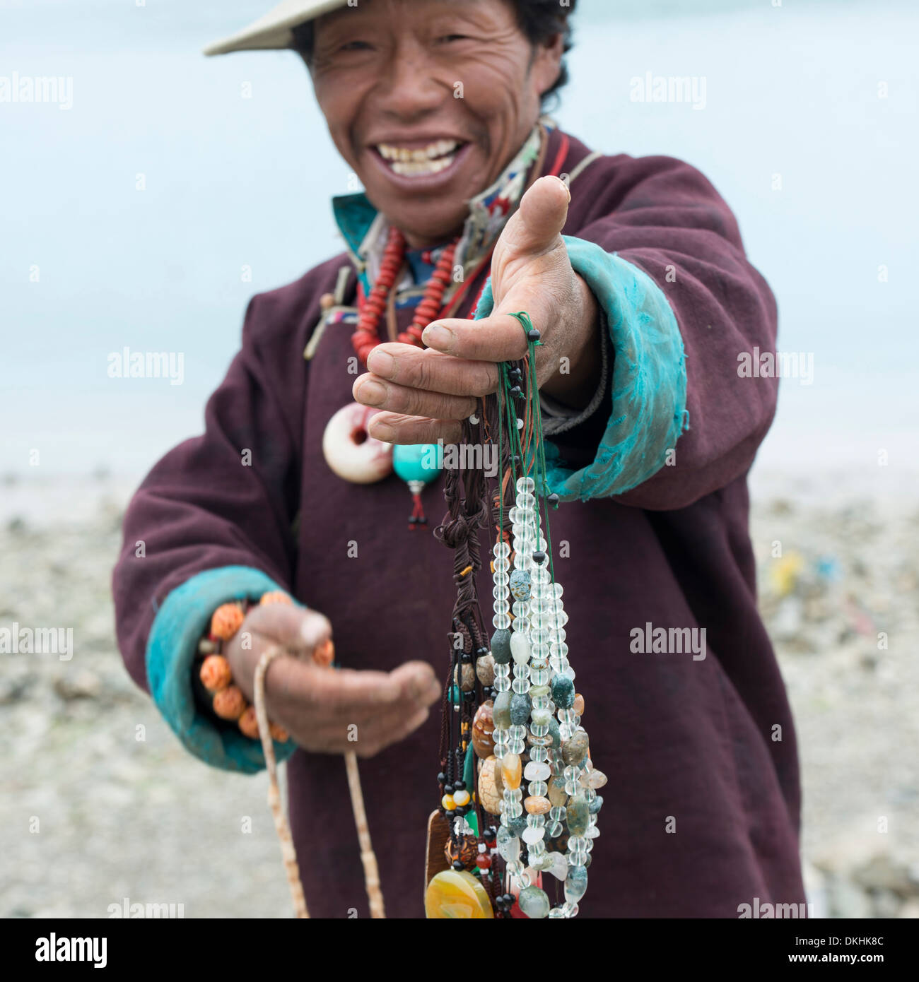 Tibetan man selling beaded necklaces, Nagarze, Shannan, Tibet, China Stock Photo