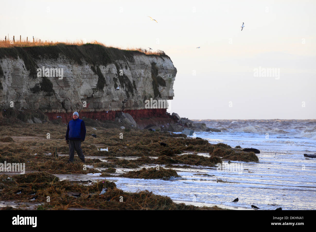 Old Hunstanton, Norfolk, UK. 6th December 2013. Debris litters the beach the morning after the biggest tidal surge in 60 years at Old Hunstanton on the Norfolk coast. Fresh cliff fall as the cliffs continue to erode. Credit:  Stuart Aylmer/Alamy Live News Stock Photo