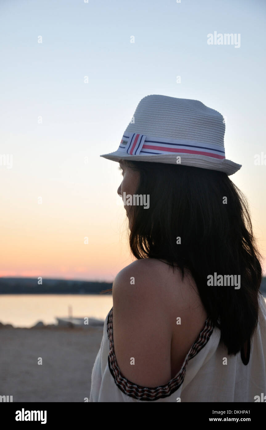 Woman alone watching sunset hi-res stock photography and images - Alamy