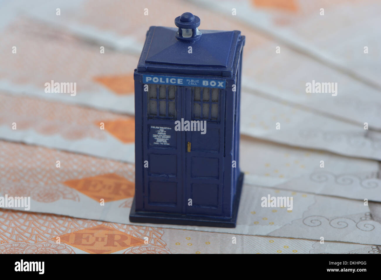 A Model Police Box On A pile Of Ten Pound Notes Stock Photo