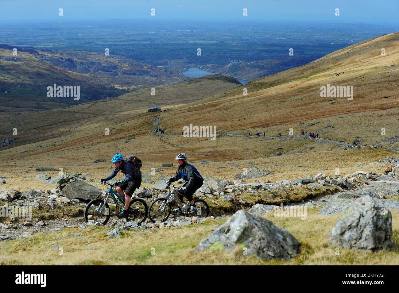Two mountain bikers ride up the Llanberis Path to the summit of Mount Snowdon in Snowdonia National Park. Stock Photo