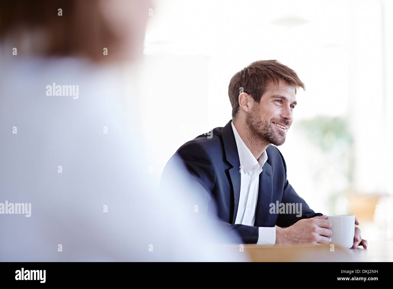 Businessman drinking cup of coffee in cafe Stock Photo