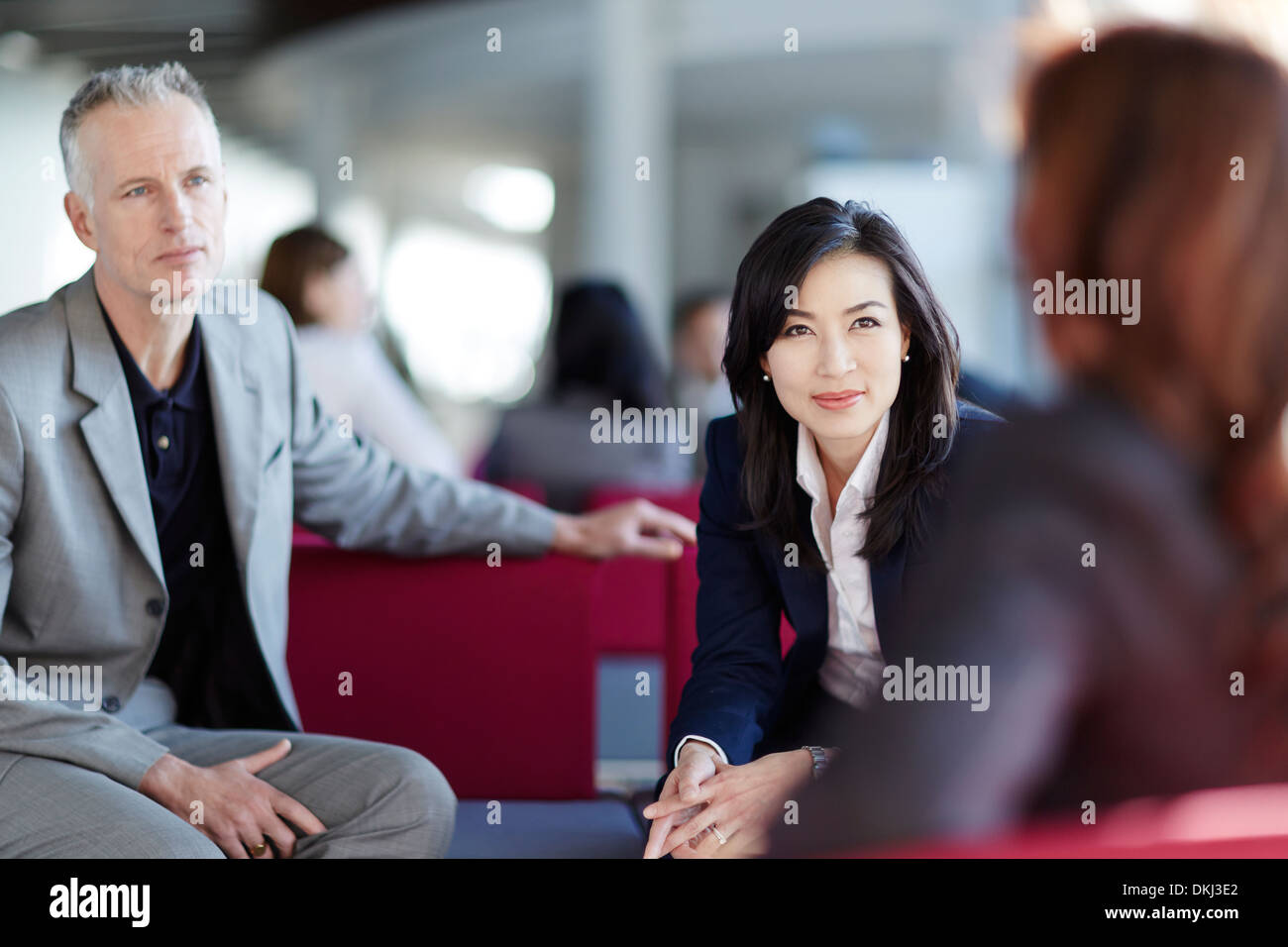 Business people talking in office lobby Stock Photo