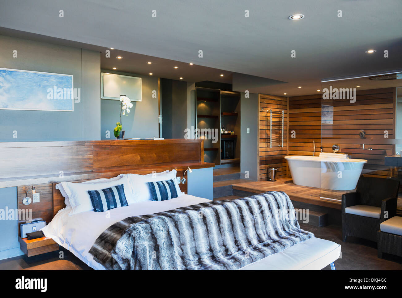 Bed And Bathtub In Modern Master Bedroom Stock Photo