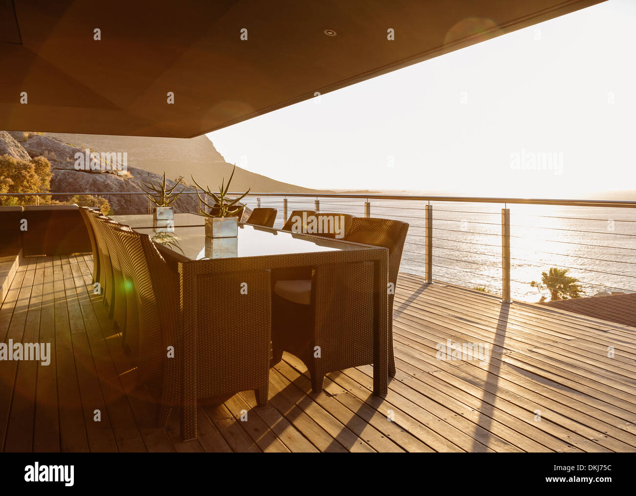 Dining table on luxury patio overlooking ocean Stock Photo