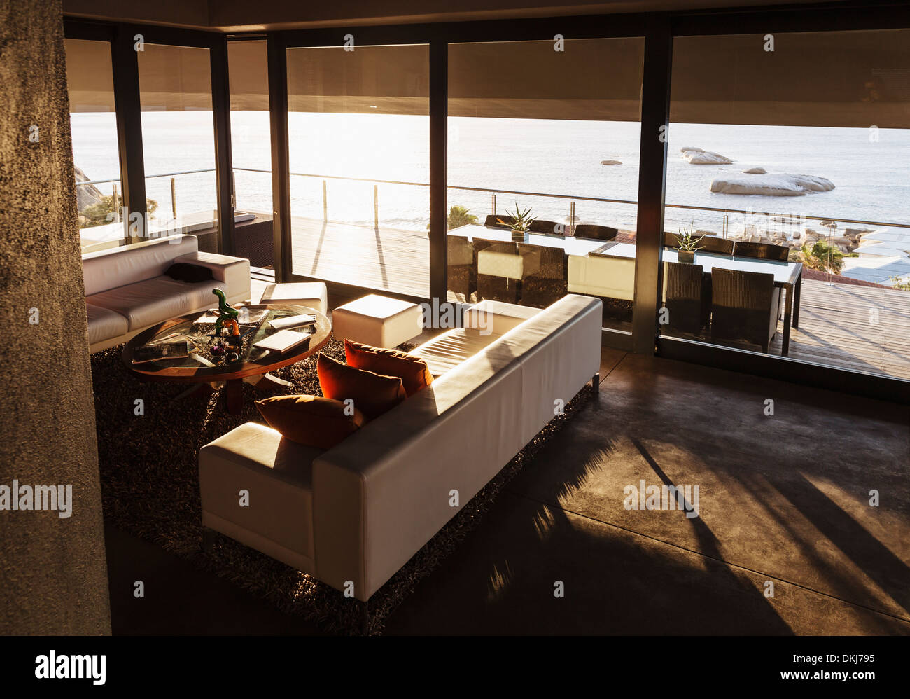 Modern living room overlooking ocean Stock Photo - Alamy