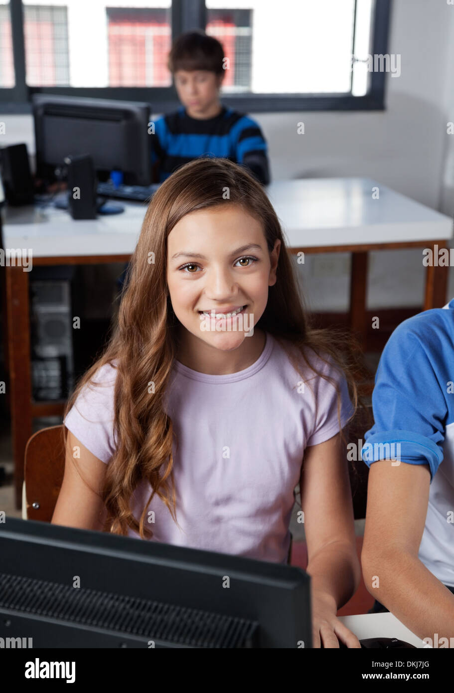 Teenage Schoolgirl Sitting In Computer Lab Stock Photo - Alamy