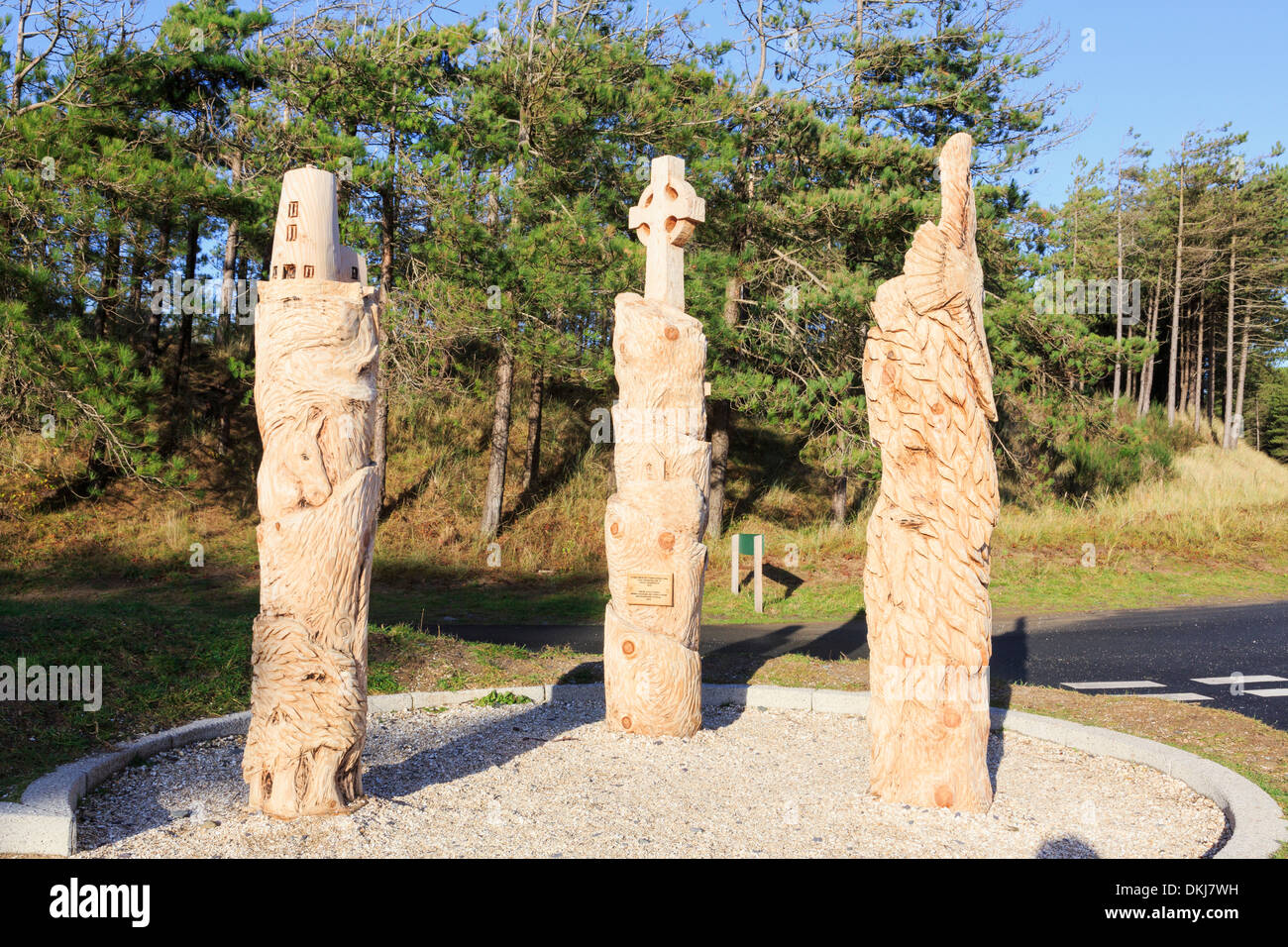Three new carved tree sculptures depicting local features on Llanddwyn
