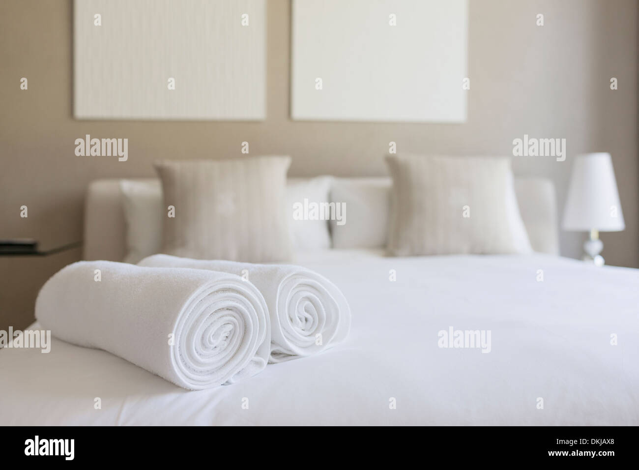 White Fluffy Towels On Bed In Hotel Bedroom Close Up View Stock