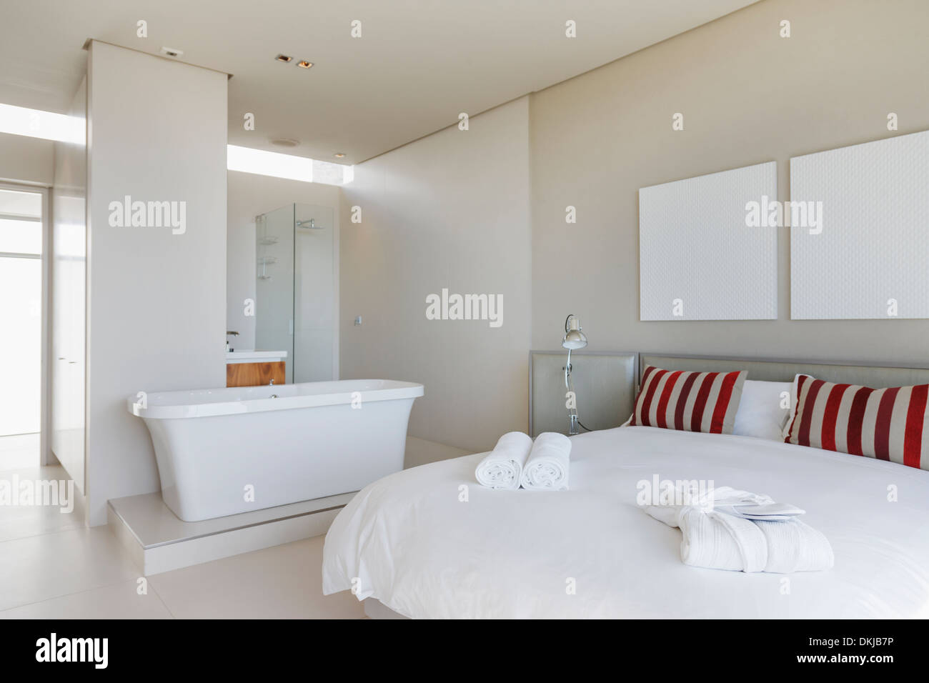 Bed and bathtub in modern bedroom Stock Photo