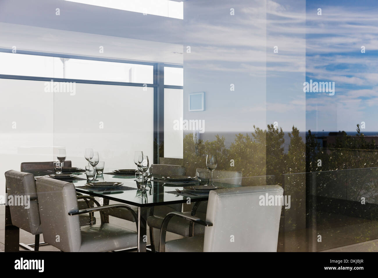 Modern dining room through window Stock Photo - Alamy