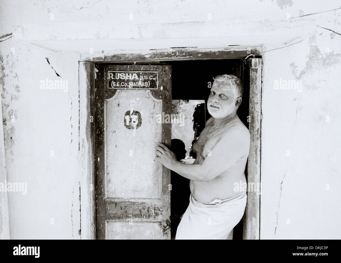 Man at home in Chennai Madras in Tamil Nadu in East india in South Asia. Indian Door Doorway House Poverty Slum Culture Life Lifestyle Travel Stock Photo