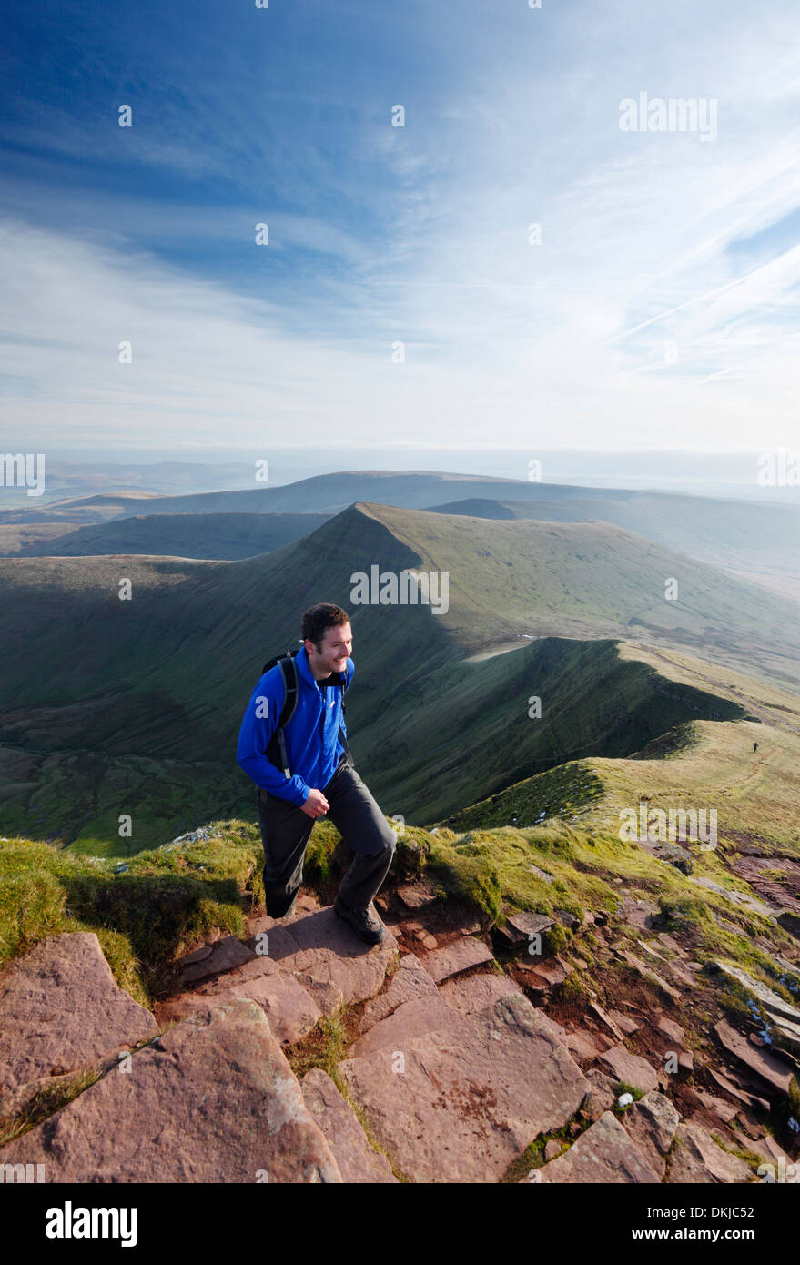 Hillwalker climbing Pen y Fan with Cribyn in the distance. Brecon Beacons National Park, Powys, Wales, UK. Stock Photo