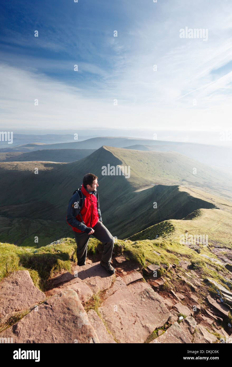 Hillwalker climbing Pen y Fan with Cribyn in the distance. Brecon Beacons National Park, Powys, Wales, UK. Stock Photo