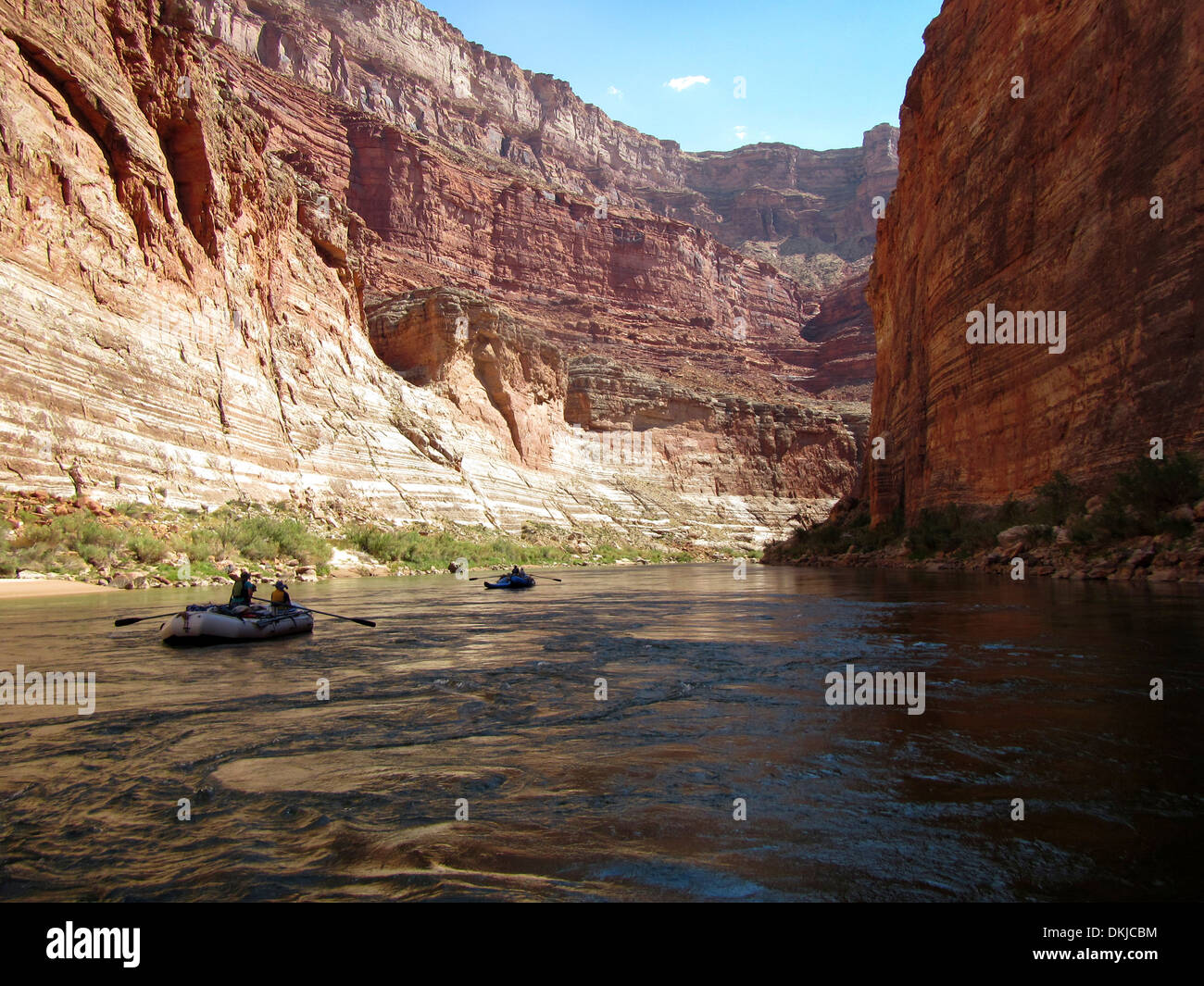 Two white water rafts row through a calm stretch of the Redwall section of the Grand Canyon. Stock Photo