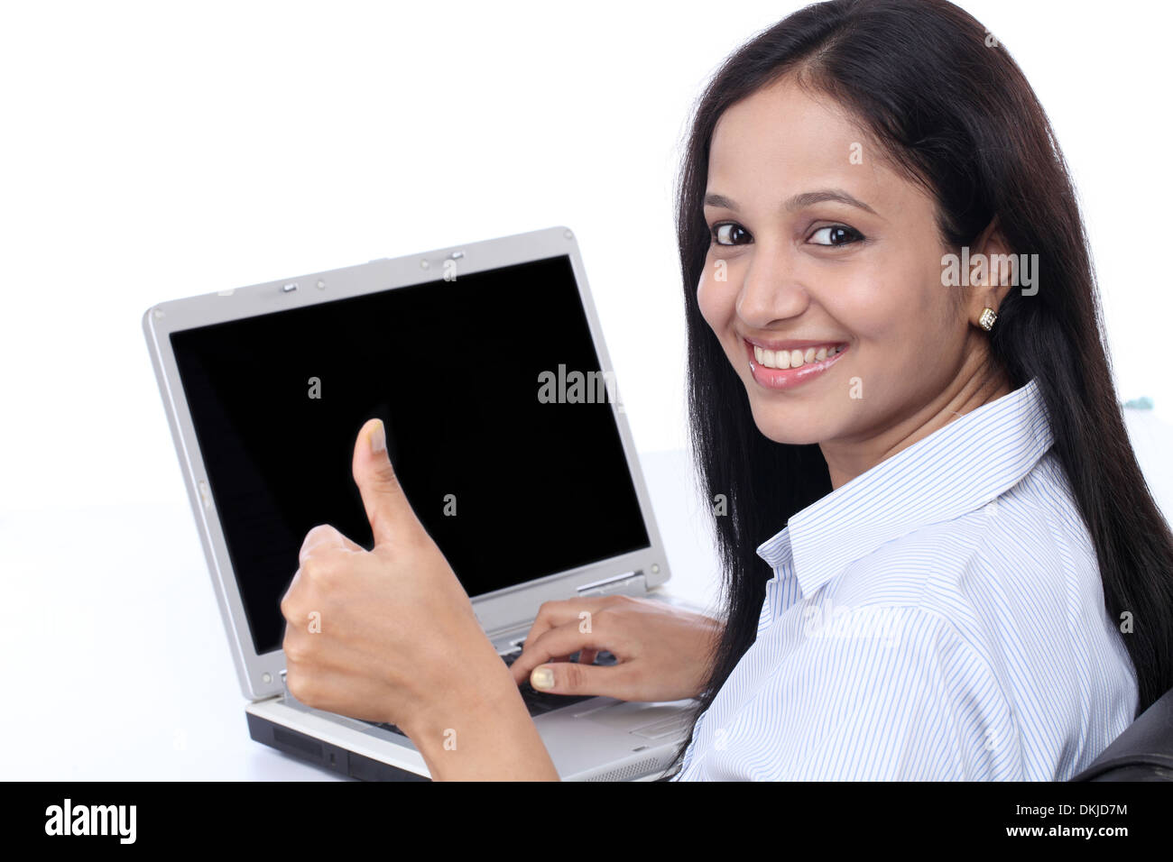 Happy young business woman showing thumbs up against white background ...