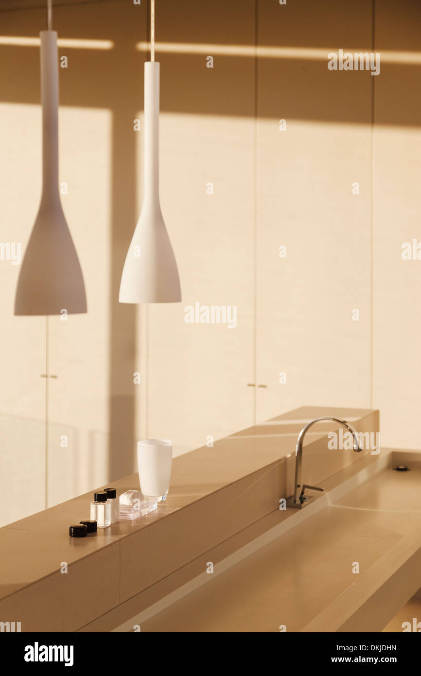 Sink and pendant light in modern bathroom Stock Photo