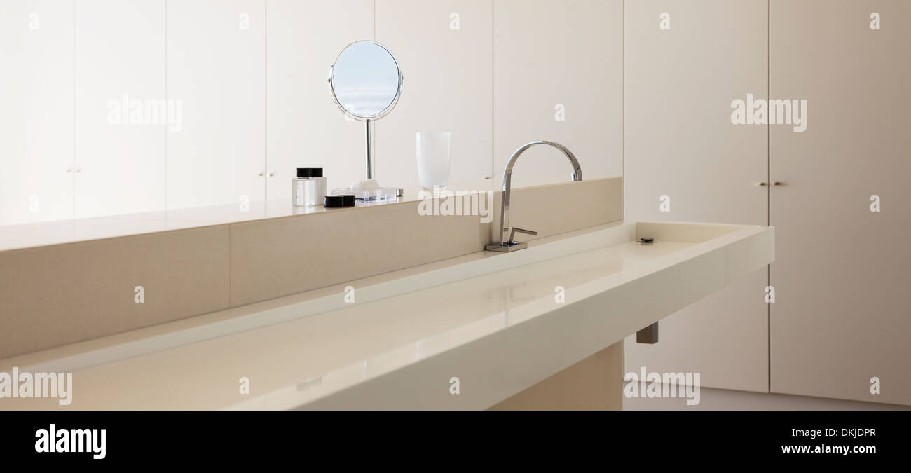 Sink and mirror in modern bathroom Stock Photo