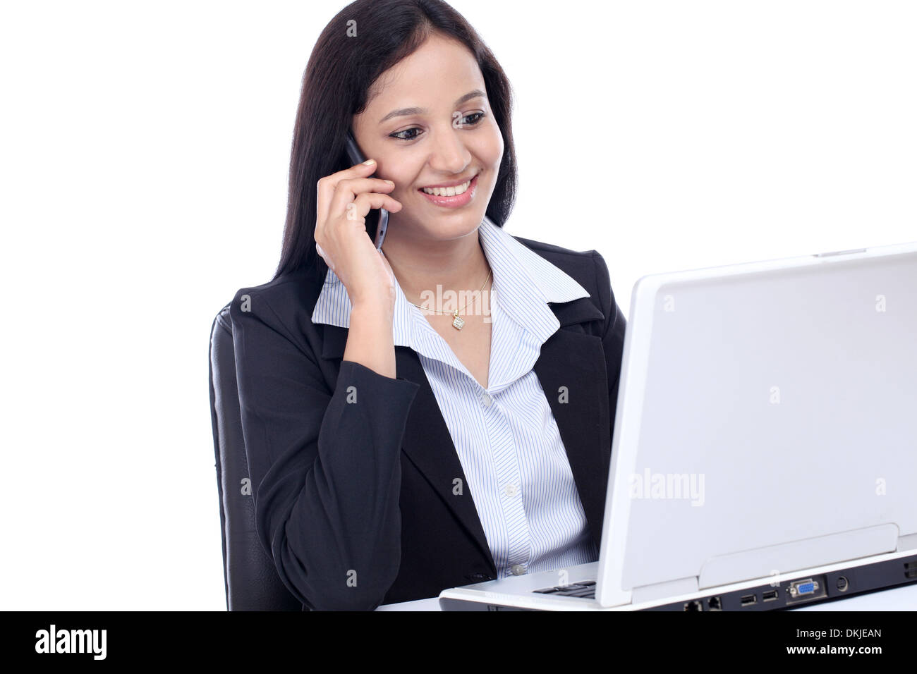Happy young business woman talking on mobile phone against white Stock Photo