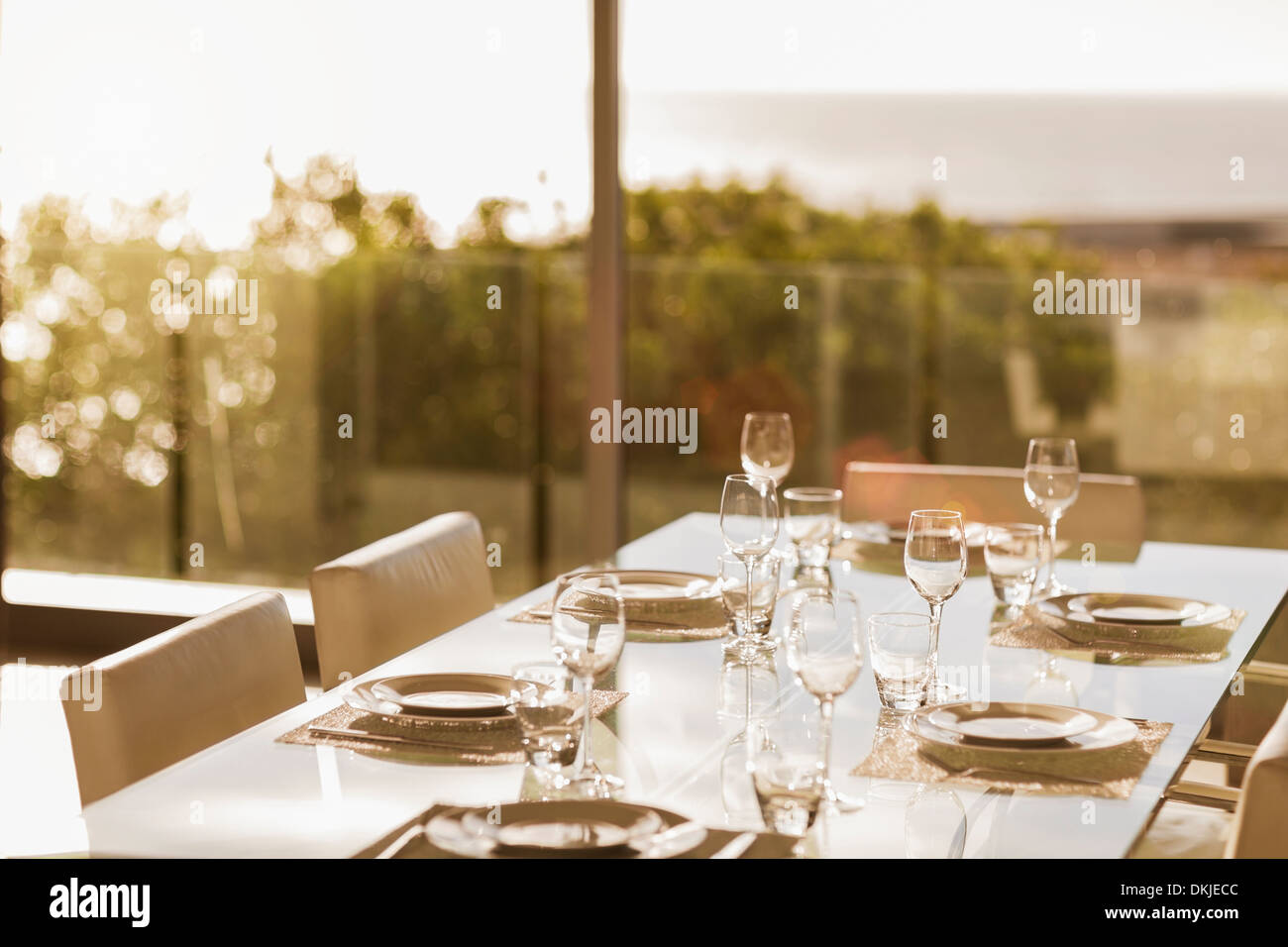 Set table in modern dining room Stock Photo