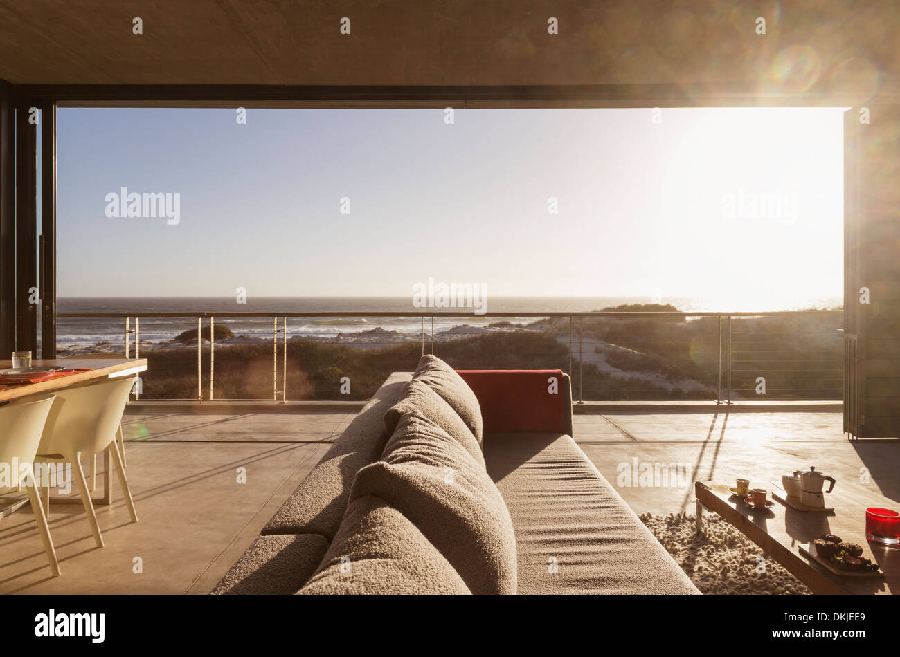 Modern living room overlooking ocean Stock Photo - Alamy