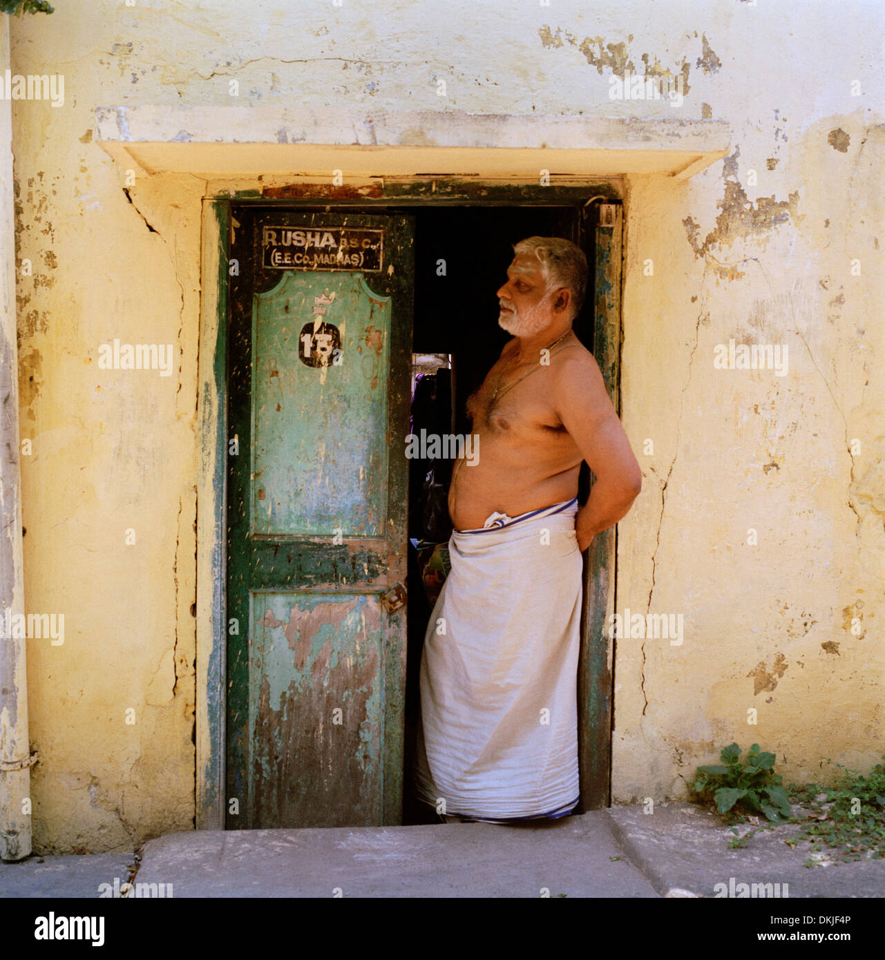 Man at home in Chennai Madras in Tamil Nadu in East india in South Asia. Indian Door Doorway House Poverty Slum Culture Life Lifestyle Travel Stock Photo