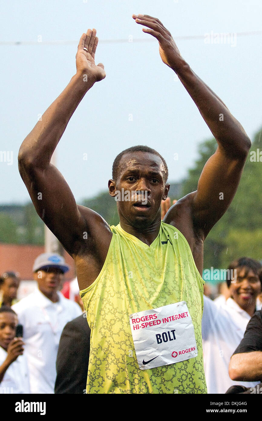 June 11, 2009 - Toronto, Ontario, Canada - 11 June 2009:  World record holder and three-time Olympic gold medalist Usain Bolt performs his talent in front of a sold-out audience of approximately 5000 fans at the University of Toronto's Festival of Excellence at the Varsity Centre. Despite rain, a wet track , and a -0.9 head wind, Usain still managed to sprint a time of ten seconds  Stock Photo