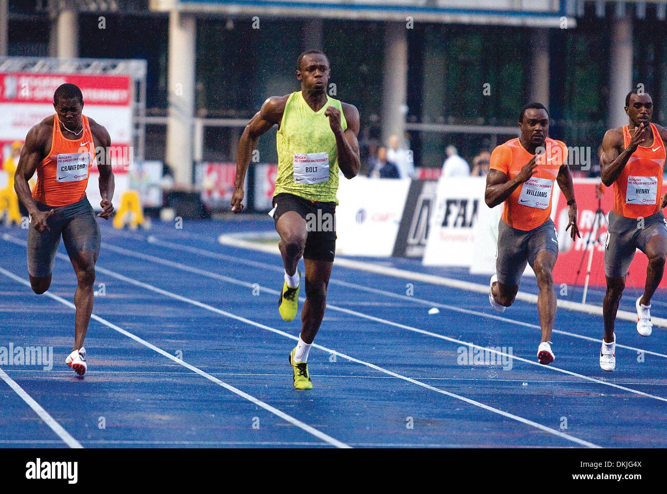 June 11, 2009 - Toronto, Ontario, Canada - 11 June 2009:  World record holder and three-time Olympic gold medalist Usain Bolt performs his talent in front of a sold-out audience of approximately 5000 fans at the University of Toronto's Festival of Excellence at the Varsity Centre. Despite rain, a wet track , and a -0.9 head wind, Usain still managed to sprint a time of ten seconds  Stock Photo