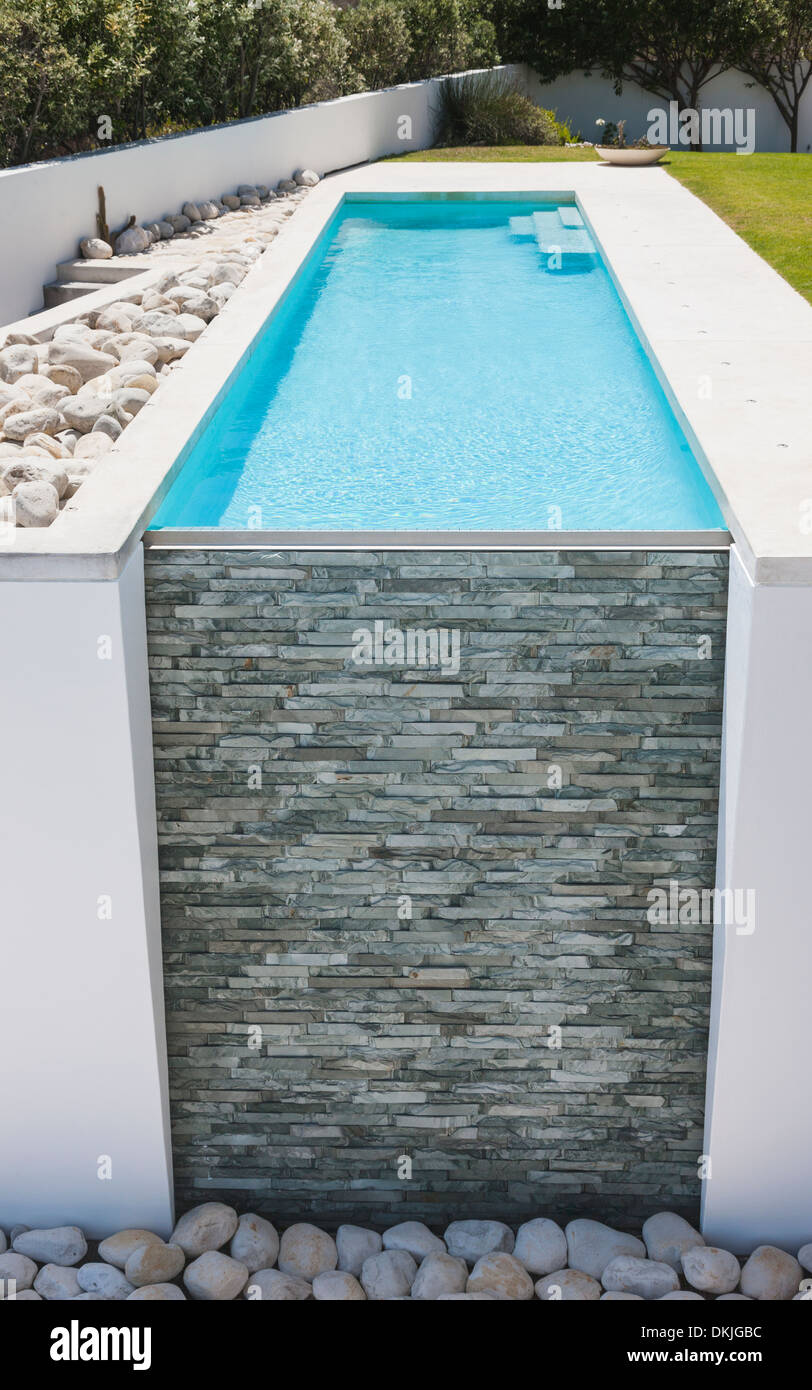 Stone wall of modern lap pool Stock Photo