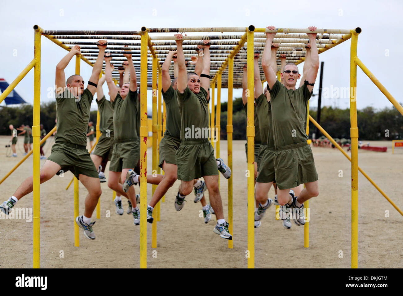 US Marine recruits climb across the monkey bars during the circuit course at boot camp October 24, 2013 in San Diego, CA. Stock Photo