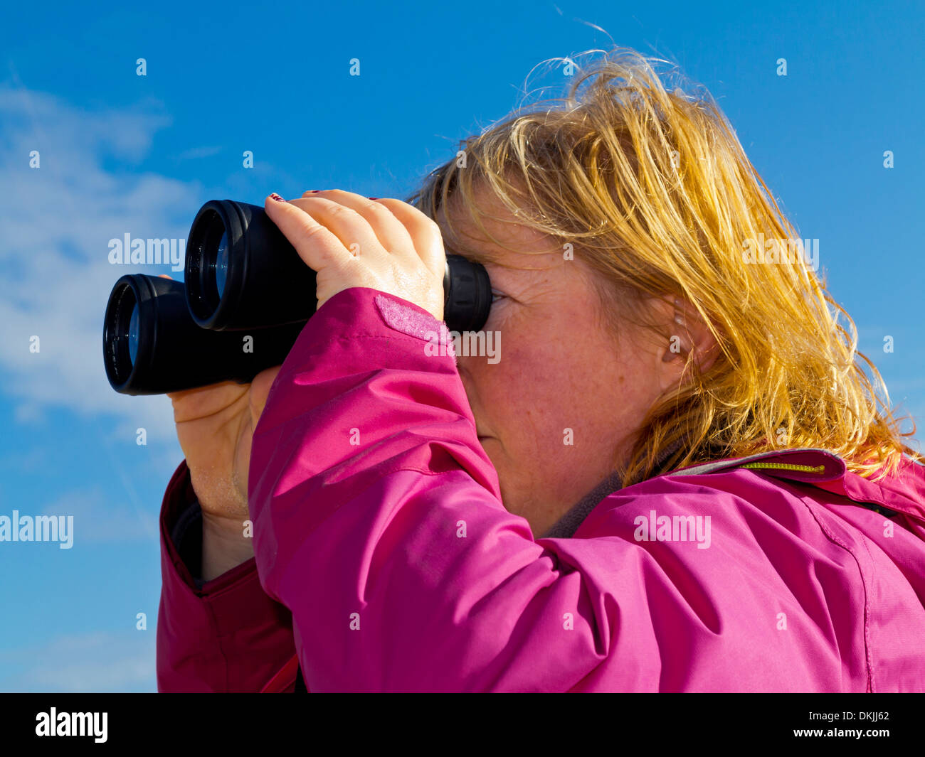 Woman With Blonde Hair And Purple Jacket Looking Through