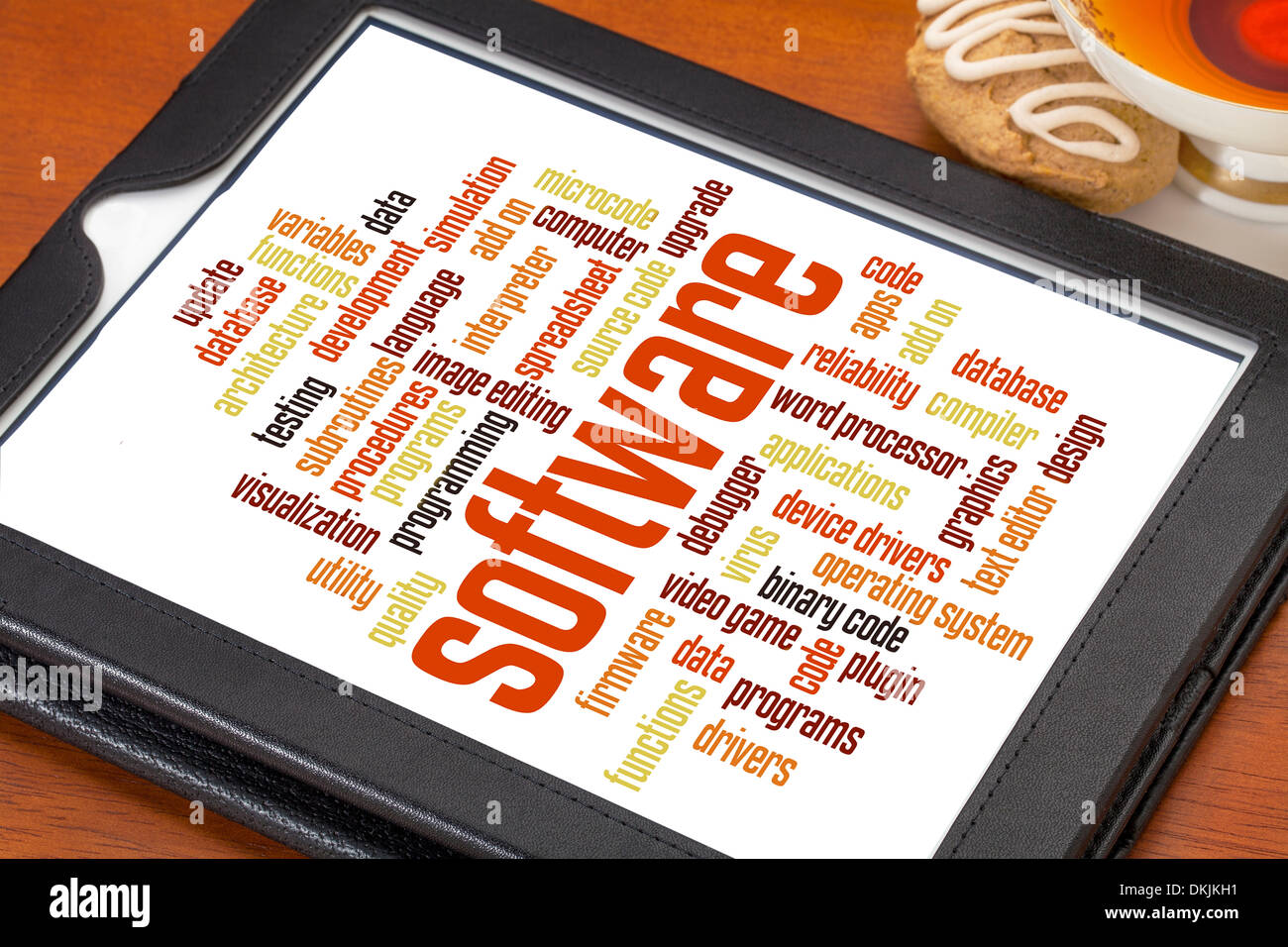 software and computer program word cloud on a digital tablet with a cup of tea Stock Photo
