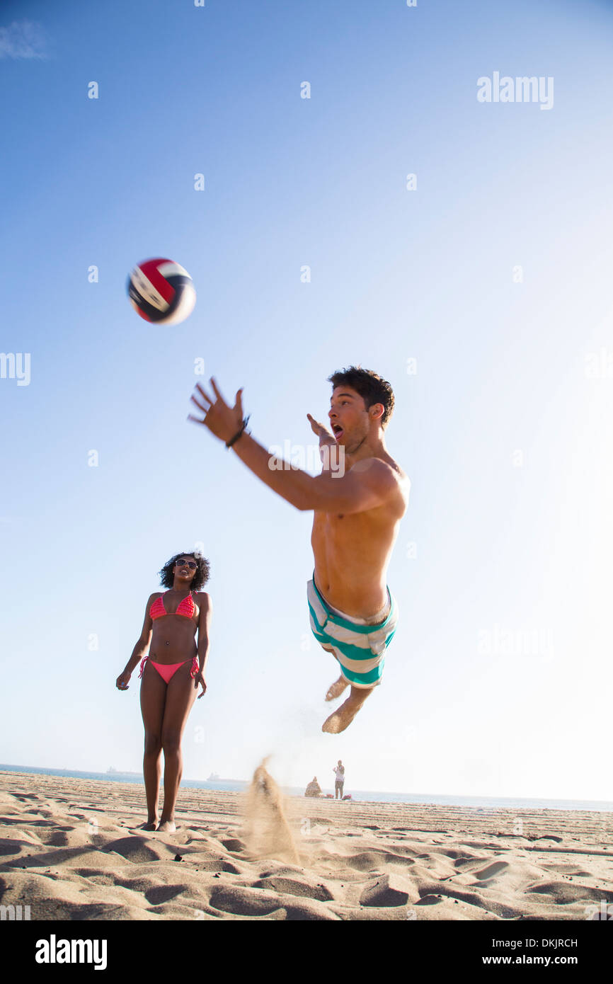 Young man diving for the volleyball Stock Photo Alamy
