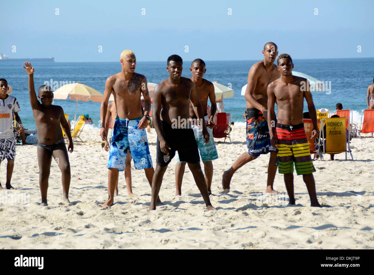 Local youths, most from the Favelas, playing a game of football on Copacabana Beach, Rio de Janeiro, Brazil. Stock Photo